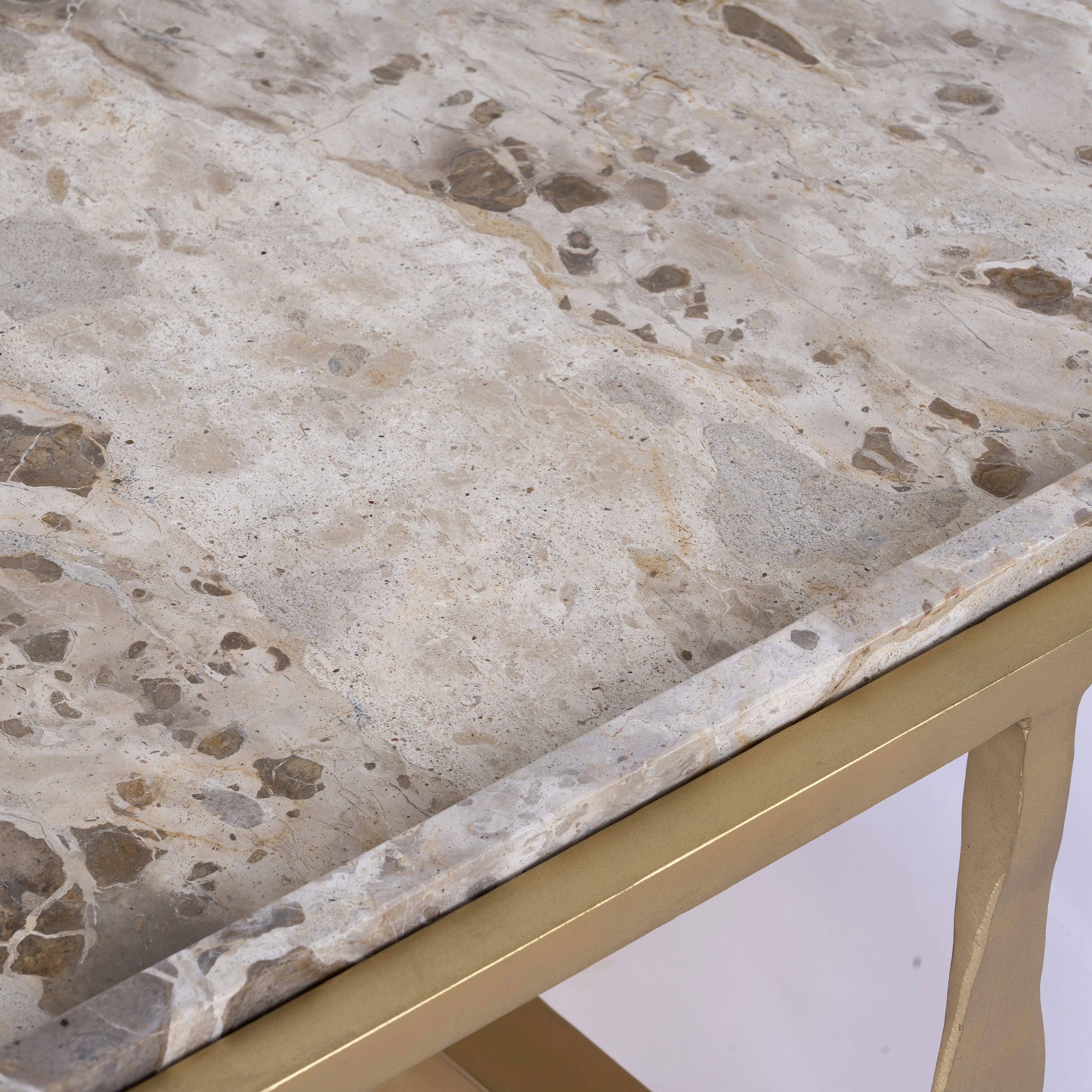 Close up image of a square metal coffee table with brown marble top and copper-finished iron base; marble top coffee table, 76 × 76 × 46 cm.