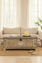Lifestyle image of a hand-painted reclaimed wood chest box with Indian motifs – vintage home decor and versatile storage with coffee table function.