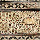 Close up image of a hand-painted Indian display cabinet with engraved Sanskrit motifs, drawer and compartments – unique Indian furniture made from recycled wood with artisanal detail.