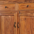 Close up image of a showcase cabinet made from reclaimed teak wood, featuring glass-panel upper doors for display, four drawers for storage, and lower cabinets with solid wood doors in a natural finish.