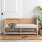 Lifestyle imagination of a mango wood and rattan furniture bench with cotton seat cushion; natural finish, 180 × 50 × 75 cm.