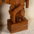 Close up image of a hand-carved Indian house guardian statue in exotic style, made from reclaimed wood; sustainable furniture, 40 × 20 × 120 cm.