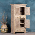 Open door picture of a wardrobe made from reclaimed wood with a sandblasted finish, featuring four carved doors, six drawers, and a light, rustic look in timeless Ibiza style.