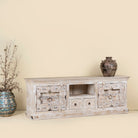 Side angle image of a wood carved sideboard made from antique teak and mango wood, whitewashed Indian furniture, Rewa design, 180 × 40 × 70 cm.