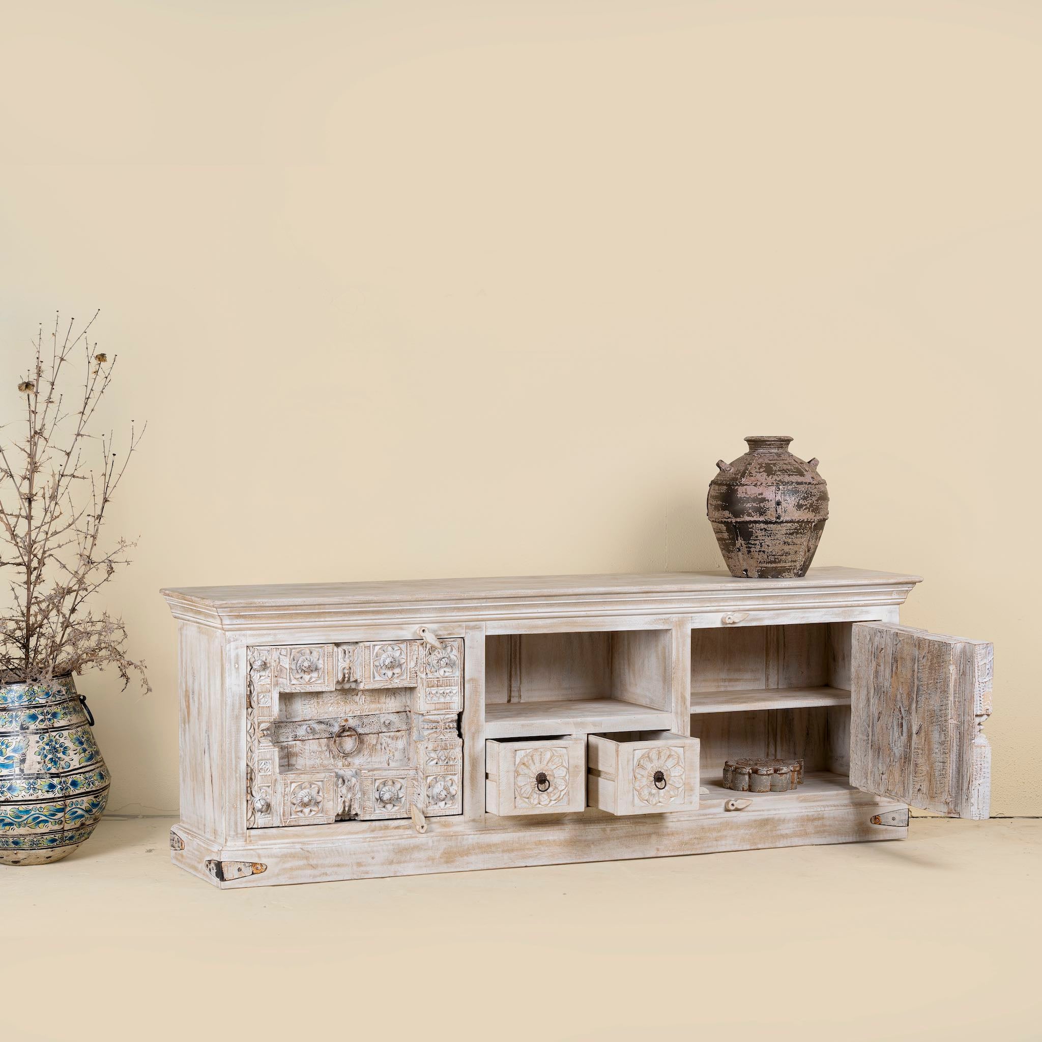 Open drawer and door image of a wood carved sideboard made from antique teak and mango wood, whitewashed Indian furniture, Rewa design, 180 × 40 × 70 cm.
