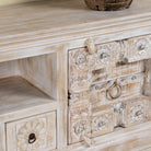 Close up picture of a wood carved sideboard made from antique teak and mango wood, whitewashed Indian furniture, Rewa design, 180 × 40 × 70 cm.