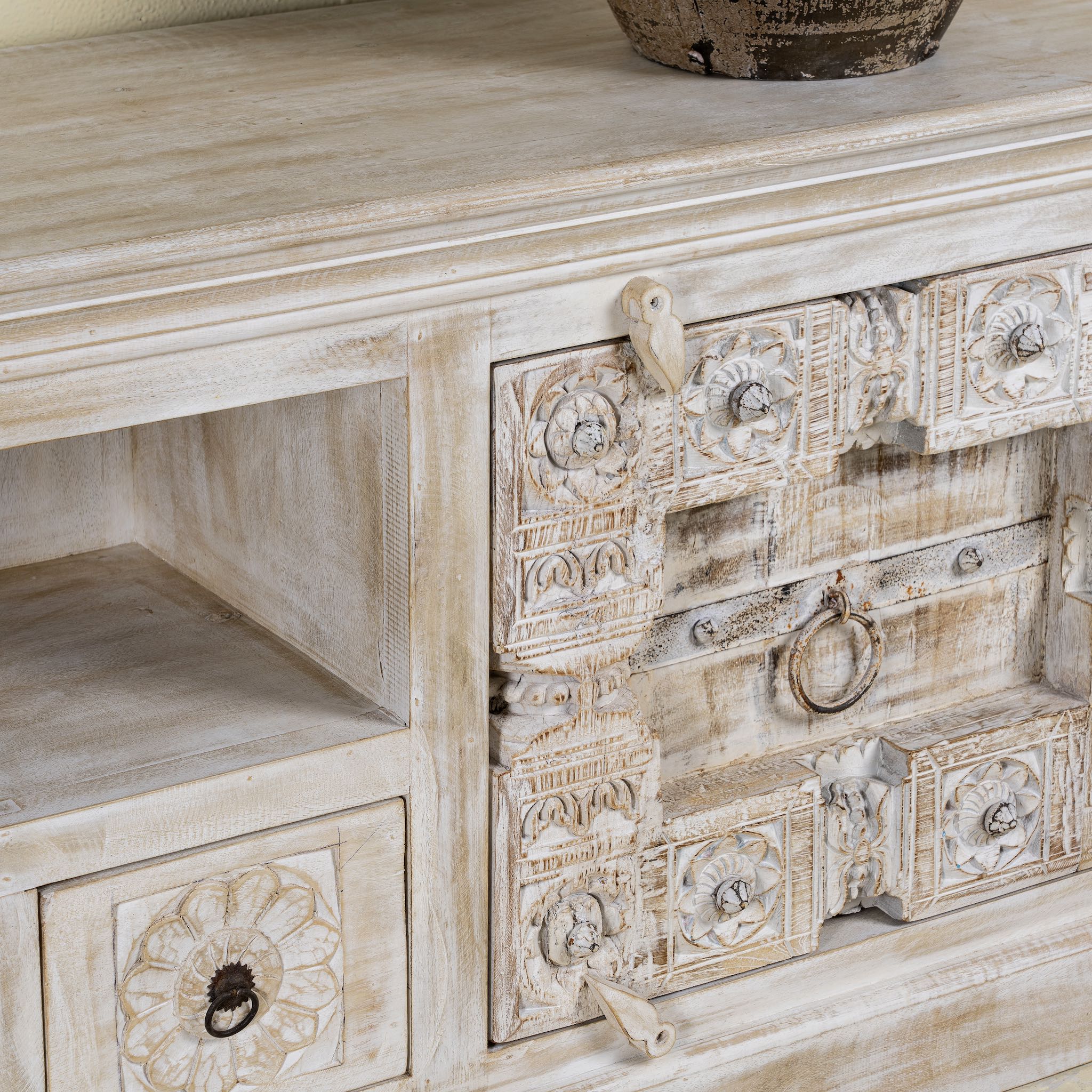 Close up picture of a wood carved sideboard made from antique teak and mango wood, whitewashed Indian furniture, Rewa design, 180 × 40 × 70 cm.