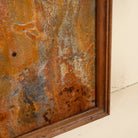 Close up image of a unique iron wall decoration featuring a naturally rusted iron panel with abstract patterns, framed in solid teak wood – ideal for modern and industrial interior decor.
