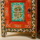 Close up image of a hand-painted bedside tables made from recycled wood – vintage night stands with carved mango wood furniture detailing and floral artistry.