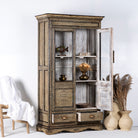 Side angle image of a hand-painted display cabinet made from recycled wood with glass doors – sustainable furniture featuring Sanskrit motifs and traditional Indian craftsmanship.