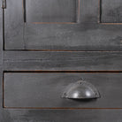 Close up image of a shabby chic grey teak wood cabinet with glass doors and drawers – sustainable furniture for classic, rustic, or vintage interiors.