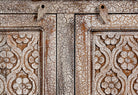Close up image of a hand‑carved vintage style mango wood sideboard with distressed floral lattice panels, 150 × 40 × 90 cm.