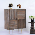 Side angle image of a grey carved cabinet in mango wood with linear carvings and brass‑plated iron base, 92 × 42 × 115 cm.