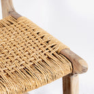 Close up image of a handcrafted Ibiza style wooden chair made from recycled teak with upholstered seat and natural weed canopy, 45 × 50 × 47 cm, backrest height 85 cm.
