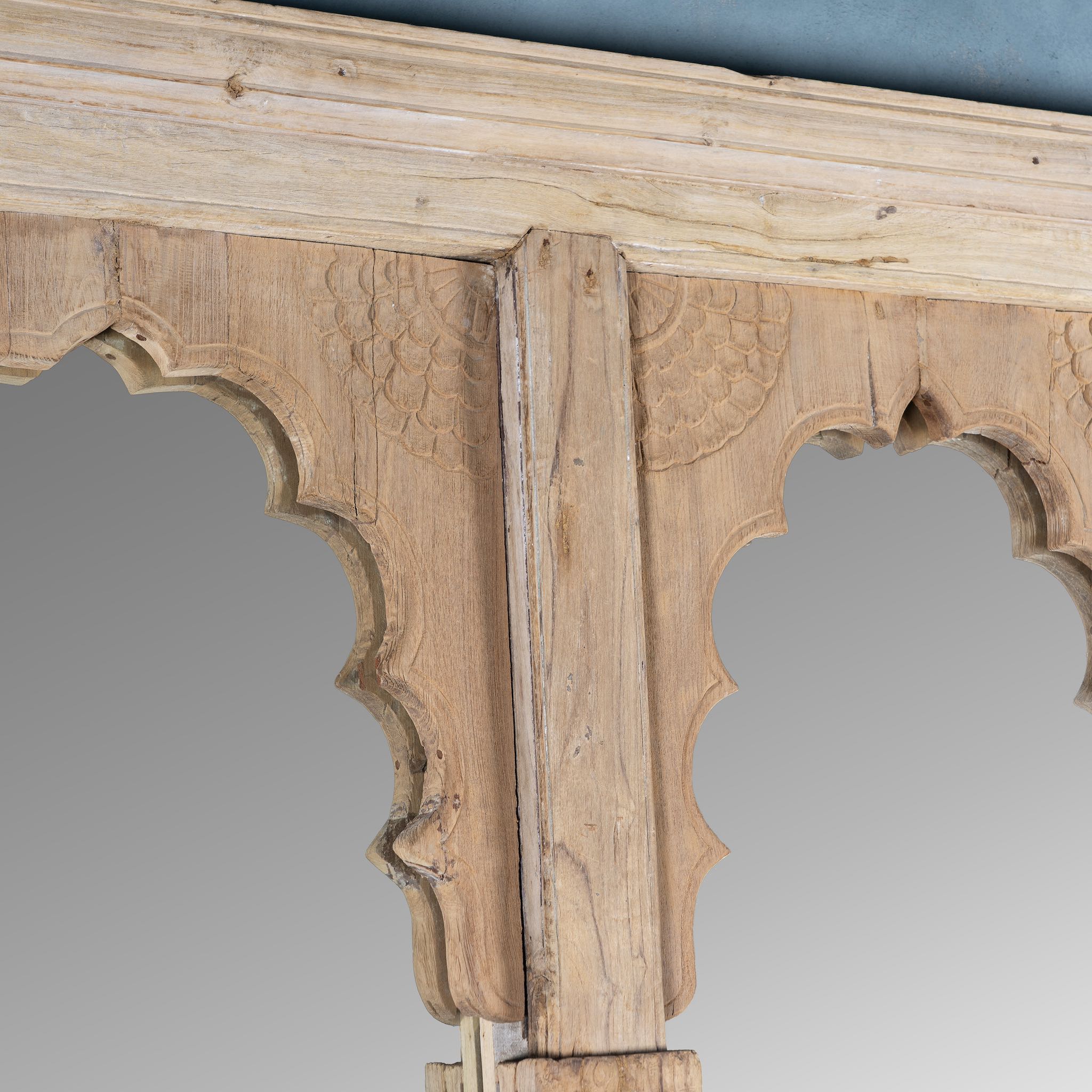Close up picture of a large arched teak wall mirror in Boho style, repurposed from antique double window frame, part of our vintage furniture collection.