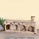 Side angle image with open drawers of a carved console table made of sandblasted mango wood with four drawers and hand-carved front; vintage entryway table, 200 × 40 × 71 cm.