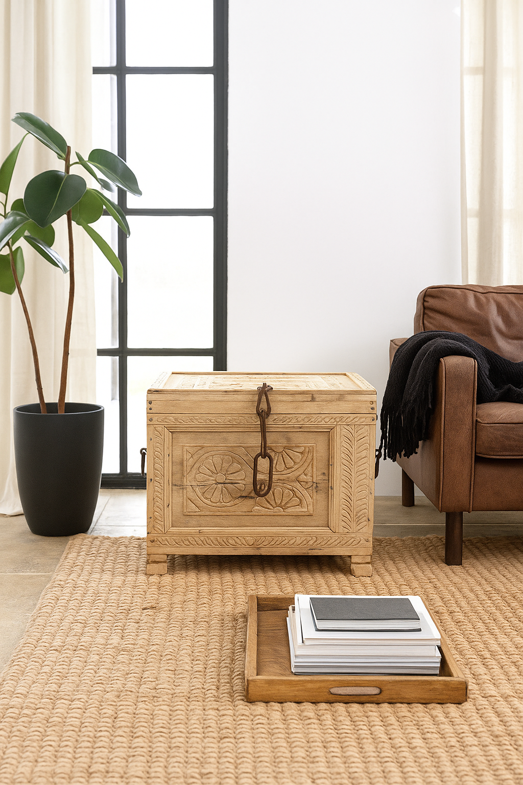 Lifestyle image of a hand-carved teak wood chest with iron details – perfect for Ibiza style interior and sustainable storage with artisanal flair.