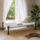 Lifestyle imagination of a handwoven Indian Charpai bed with reclaimed teak frame and carved legs; perfect for Indian home decor, 170 × 105 × 45 cm.