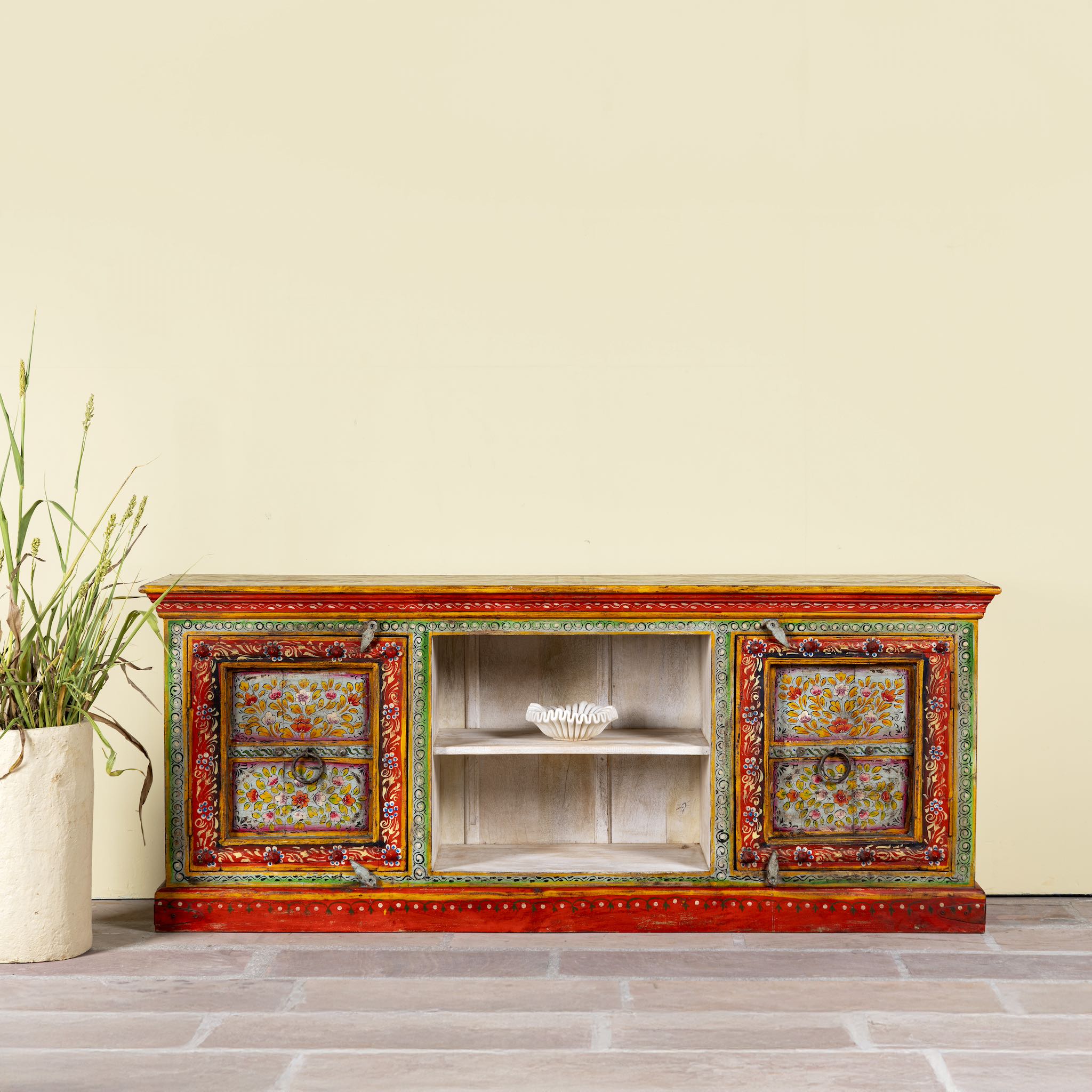 Hand-painted reclaimed wood vintage lowboard with floral motifs – a colourful piece of sustainable furniture for artistic and rustic interiors.