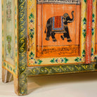 Close up image of the leg part of a hand painted reclaimed wood furniture cabinet with Indian god motifs, vintage furniture with cultural detailing, 90 × 40 × 150 cm.