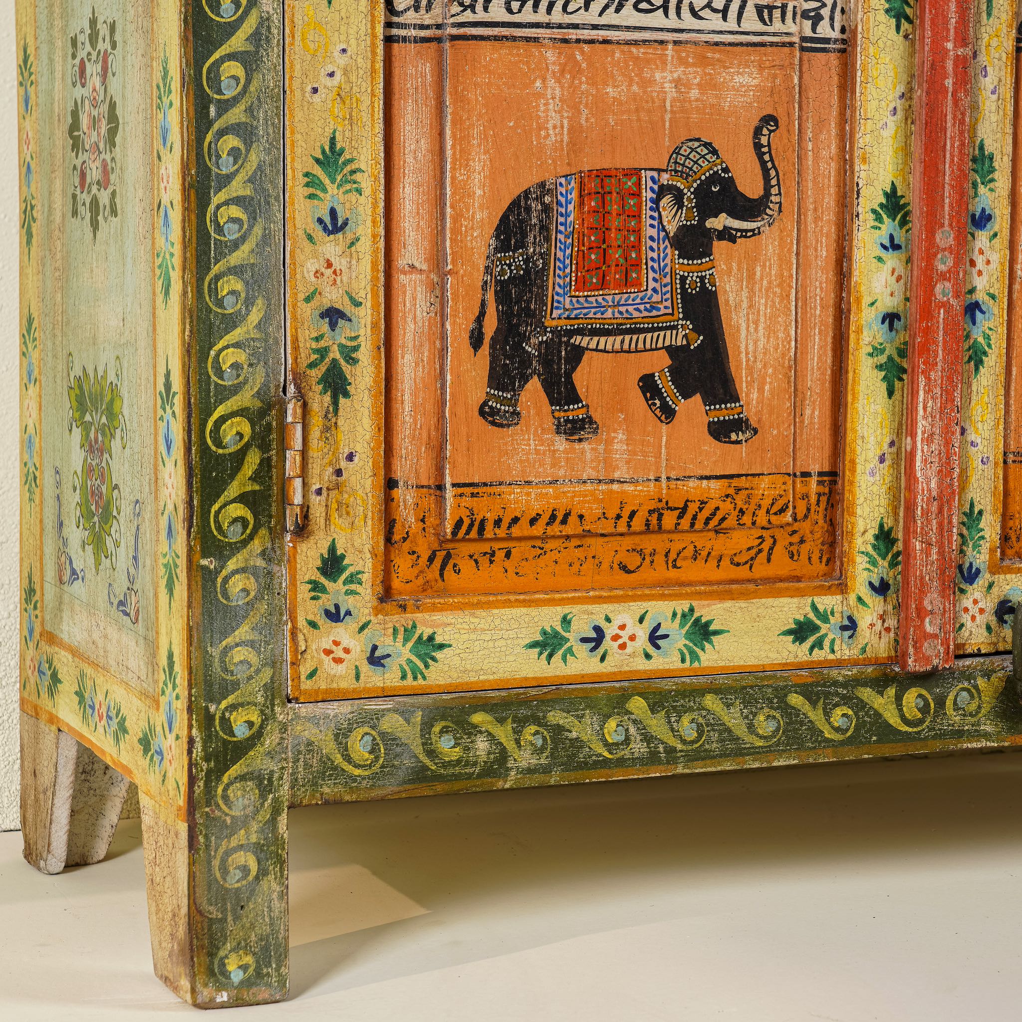 Close up image of the leg part of a hand painted reclaimed wood furniture cabinet with Indian god motifs, vintage furniture with cultural detailing, 90 × 40 × 150 cm.