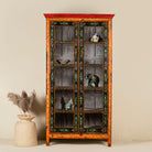 A vintage style hand-painted reclaimed wood showcase with floral motifs, featuring four compartments and a vibrant red door.