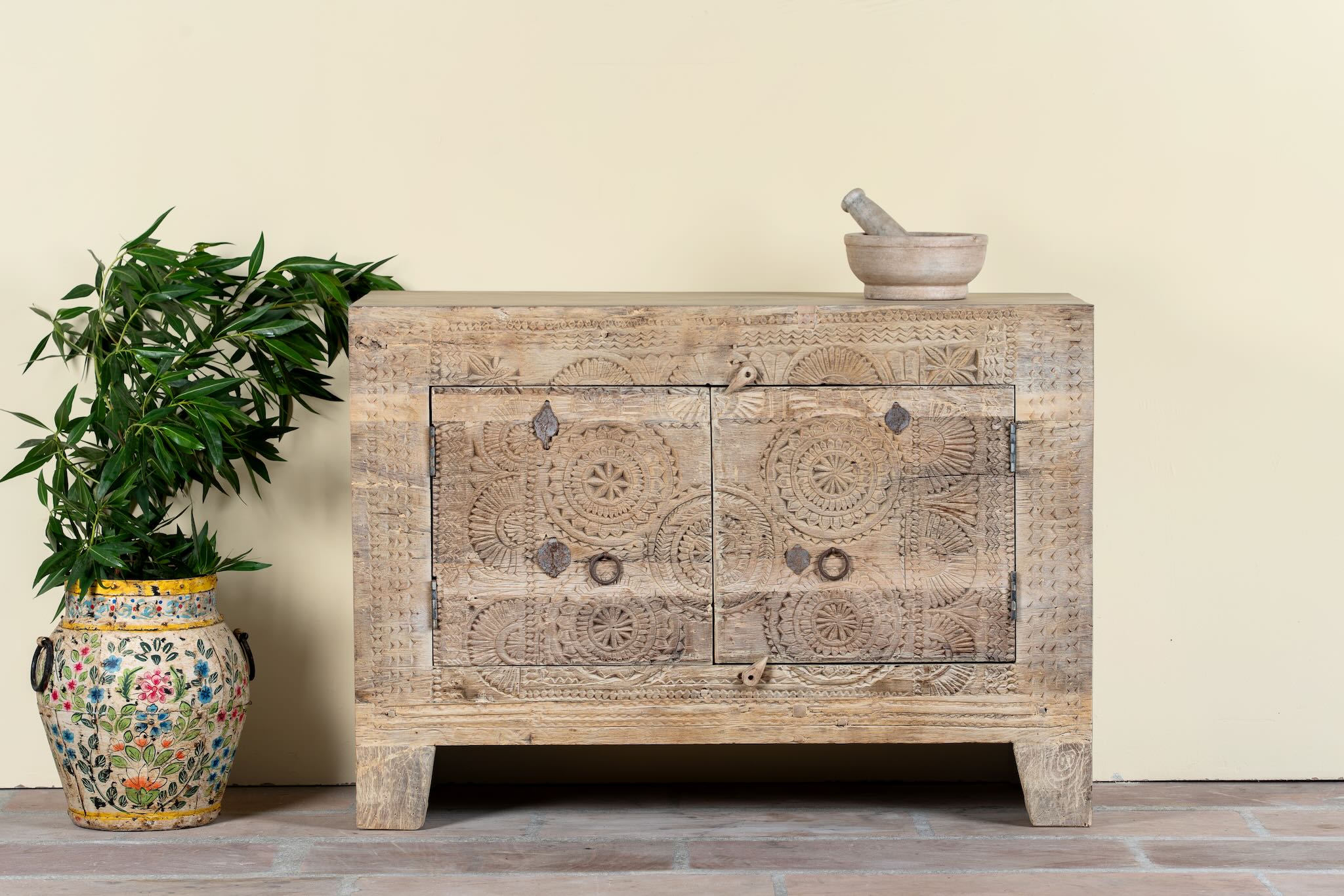 Sideboard Taksh made from reclaimed teak wood, featuring carved antique Indian door fronts with circular mandala motifs. A unique piece of old door furniture combining Mediterranean style with traditional Indian craftsmanship.