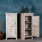 Open door image of a white washed wood cabinet with hand-carved floral design, Moroccan-style reclaimed wood furniture, 134 × 60 × 45 cm.
