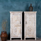 White washed wood cabinet with hand-carved floral design, Moroccan-style reclaimed wood furniture, 134 × 60 × 45 cm.