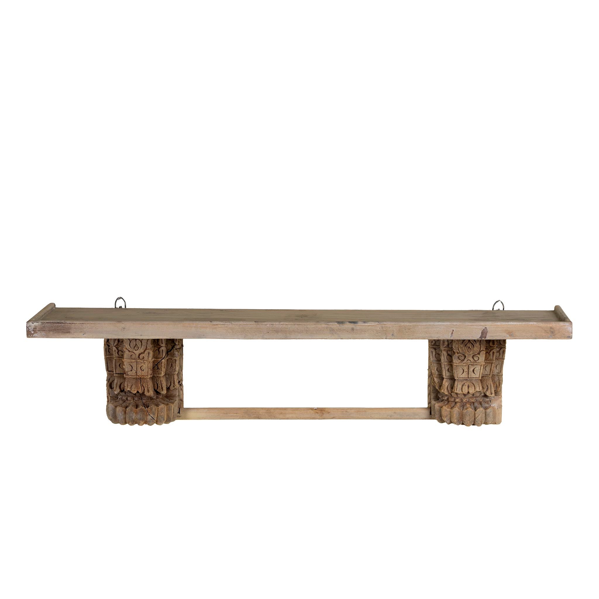 White background image of a unique wall shelf made of reclaimed teak wood with carved supports from Indian house parts; rustic vintage home accessories, 100 × 20 × 15 cm.