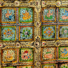 Close up image of a hand painted wardrobe made of teak wood with floral motifs; unique furniture inspired by Indian artistry, 104 × 50 × 186 cm.