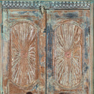 Close up image of a hand-carved reclaimed wood wardrobe with vintage sunburst design – a sustainable furniture piece perfect for Indian home decor and rustic interiors.