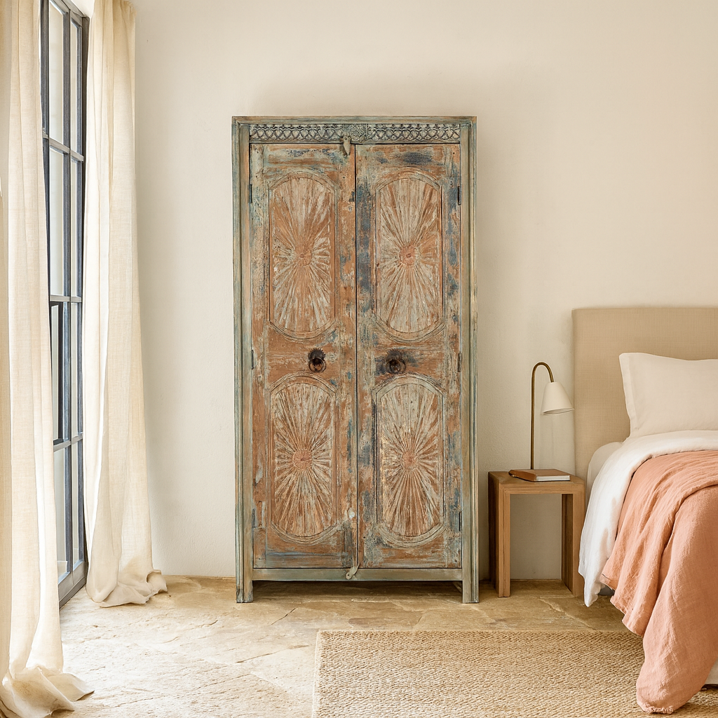 Lifestyle scene with a hand-carved reclaimed wood wardrobe with vintage sunburst design – a sustainable furniture piece perfect for Indian home decor and rustic interiors.