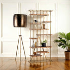 A brass-plated iron shelf with mango wood trays, featuring a copper finish on the iron and natural wood grain on the trays, placed in a room with decorative items on it.