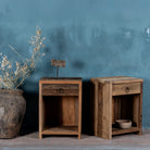 Side view image of a pair of bedside tables in Driftwood/ Wabi Sabi style crafted from recycled old wood, each featuring a single drawer with a metal ring pull and an open shelf below, showcasing natural wood grain and rustic textures.


