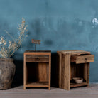 Side view image with open drawer of a pair of bedside tables in Driftwood/ Wabi Sabi style crafted from recycled old wood, each featuring a single drawer with a metal ring pull and an open shelf below, showcasing natural wood grain and rustic textures.


