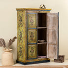 Open door image of a hand painted wardrobe made from reclaimed wood with floral motifs and distressed finish; ideal for a boho chic living room or eclectic bedroom, 90 × 40 × 150 cm.