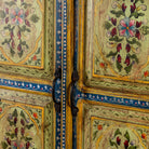 Close up picture of a hand painted wardrobe made from reclaimed wood with floral motifs and distressed finish; ideal for a boho chic living room or eclectic bedroom, 90 × 40 × 150 cm.