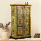 Side angle image of a hand painted wardrobe made from reclaimed wood with floral motifs and distressed finish; ideal for a boho chic living room or eclectic bedroom, 90 × 40 × 150 cm.