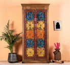Hand-painted cabinet made from reclaimed teak wood with colourful Indian motifs – sustainable furniture and vintage teak wood craftsmanship for bold interiors.