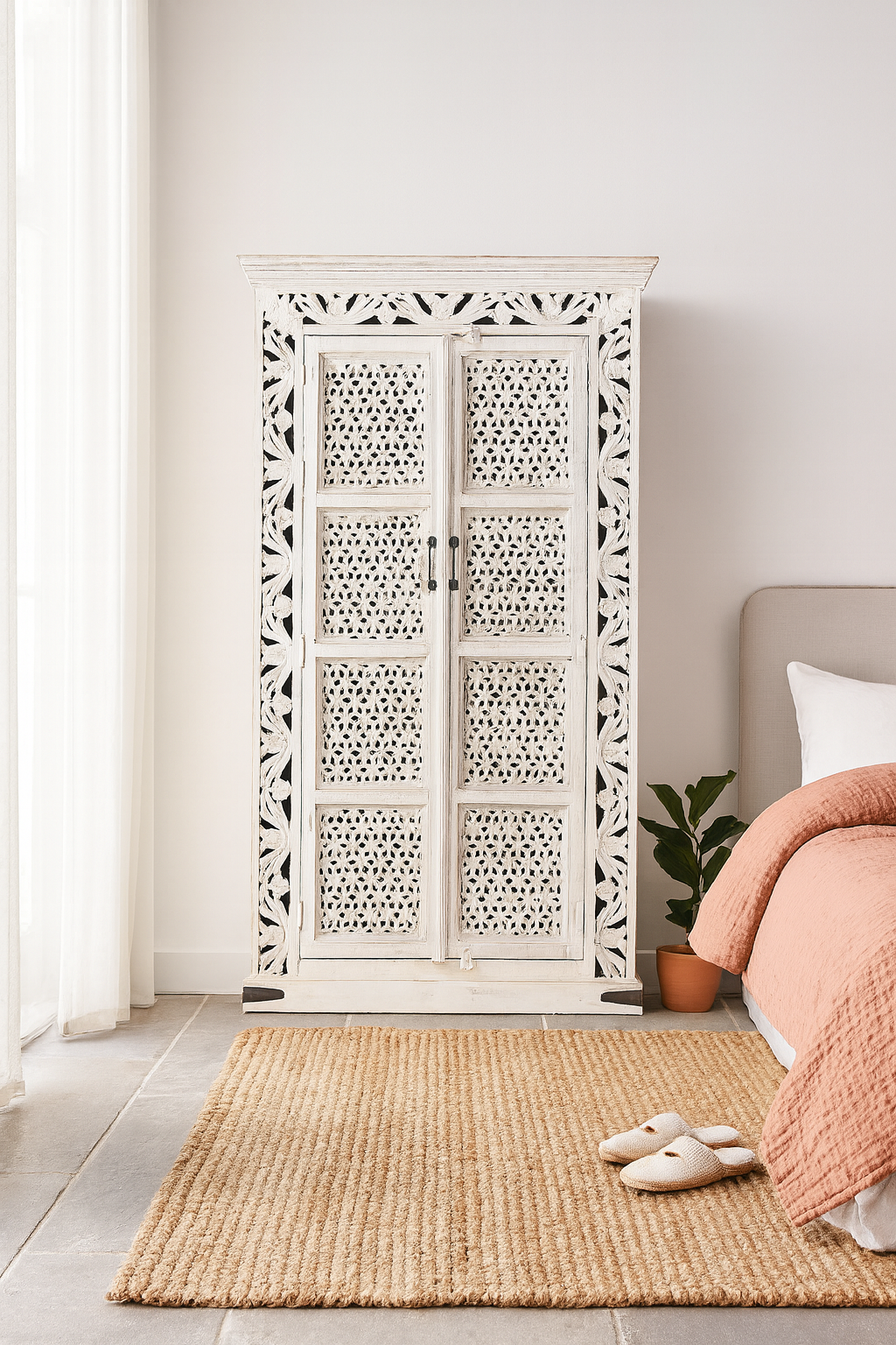 Lifestyle image of a hand-carved mango wood cabinet with floral and geometric patterns in white-wash finish – carved wooden furniture and artisanal furniture with Mediterranean charm.