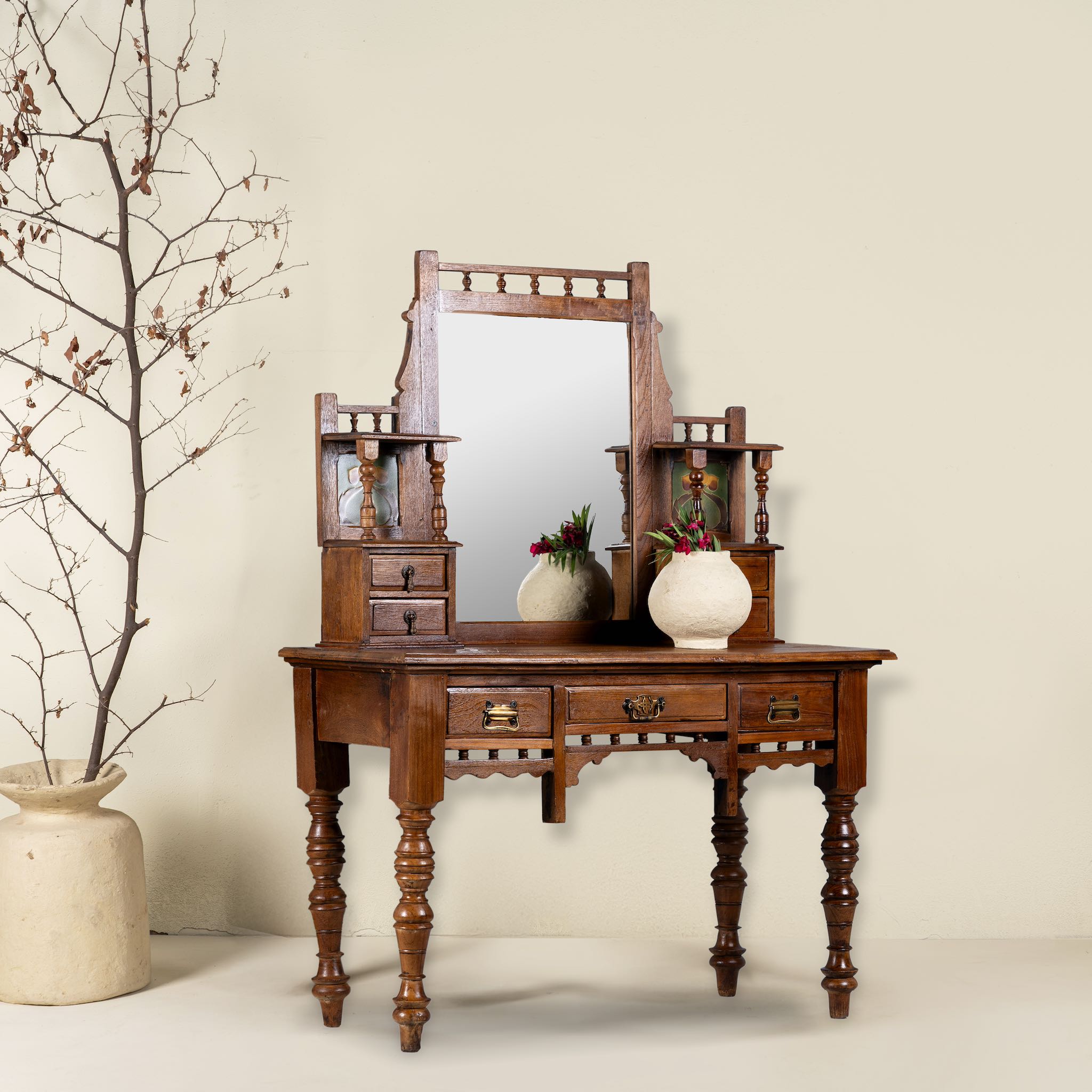 Side angle image of a antique console table with mirror, restored teak wood, featuring hand-carved detailing; dressing table with mirror, 110 × 48 × 146 cm.
