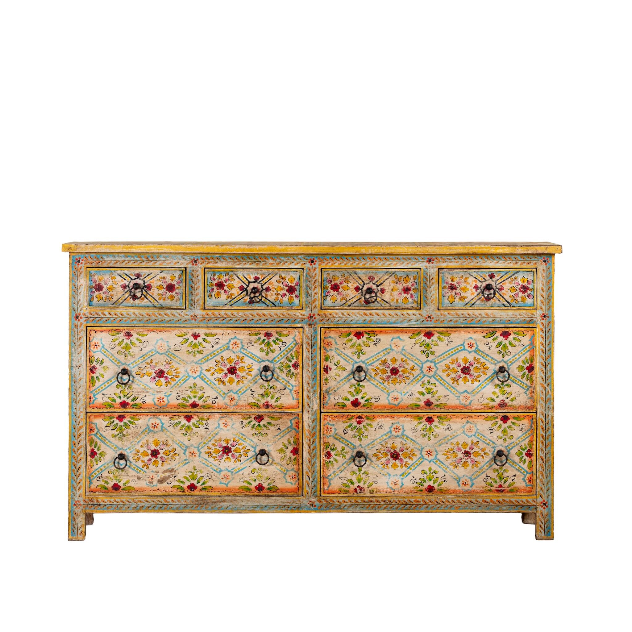 White background image of a Ziya hand‑painted chest of 8 drawers made from reclaimed wood with floral motifs and iron handles—an artisan piece of painted wooden furniture.