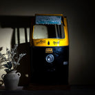 Lifestyle image of a artsy bar table made from a reclaimed Indian rickshaw front with working headlight – Zoha Riksha bar model by Om Home & Garden