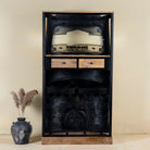 Unique bar table crafted from the front part of an old Indian rickshaw, featuring vibrant yellow and black paint with original details and functioning light.