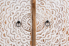 Close up image of a carved wood furniture cupboard with white-washed engraved doors and mango wood body, 90 × 90 × 40 cm.