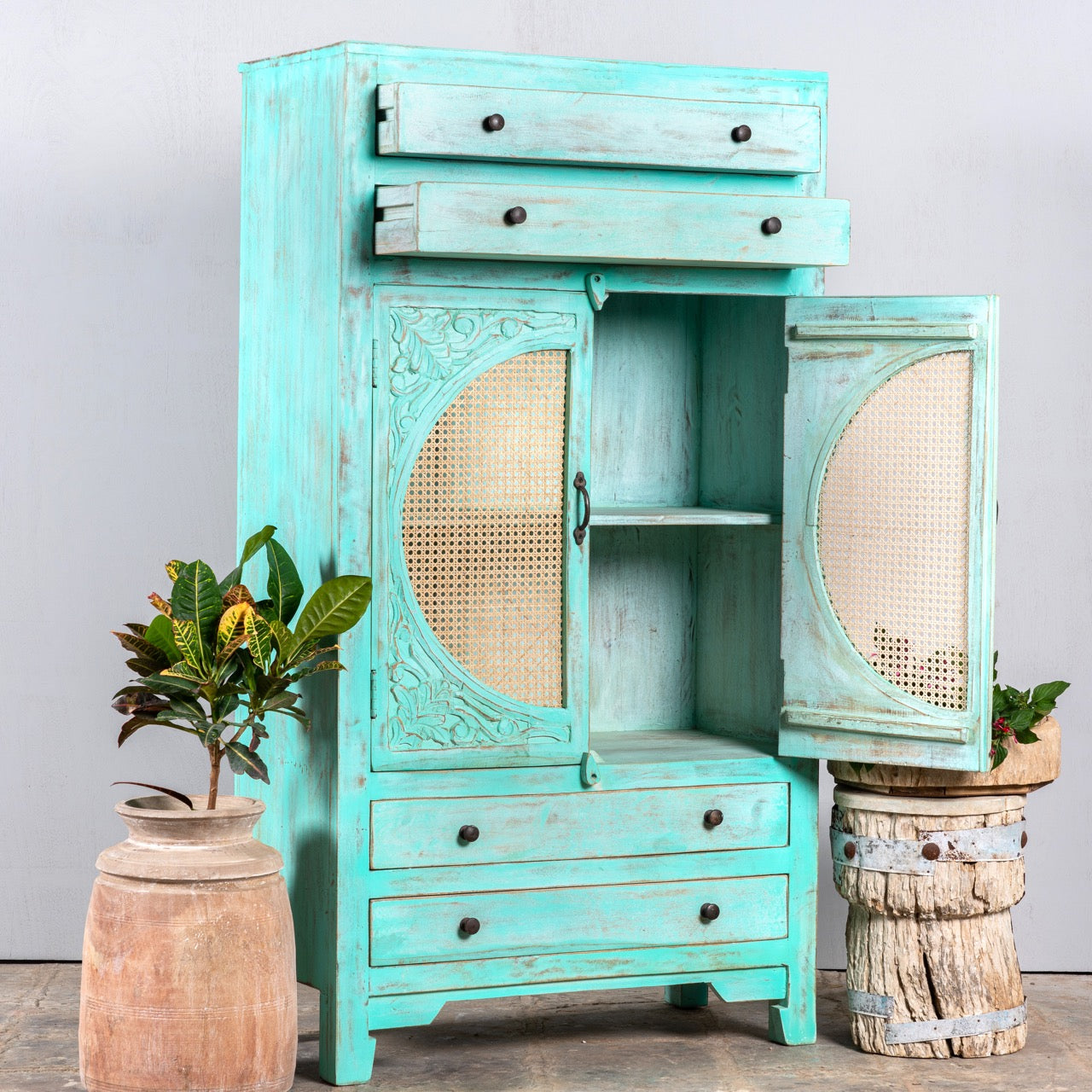 Open door image of a vintage furniture cabinet in turquoise-washed mango wood with rattan door panels and hand-carved engravings, 80 × 148 × 40 cm.