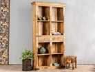 Side angle image of a handcrafted mango wood bookshelf with carved detailing – mango wood shelving and carved wooden furniture in a warm brown finish for timeless interiors.