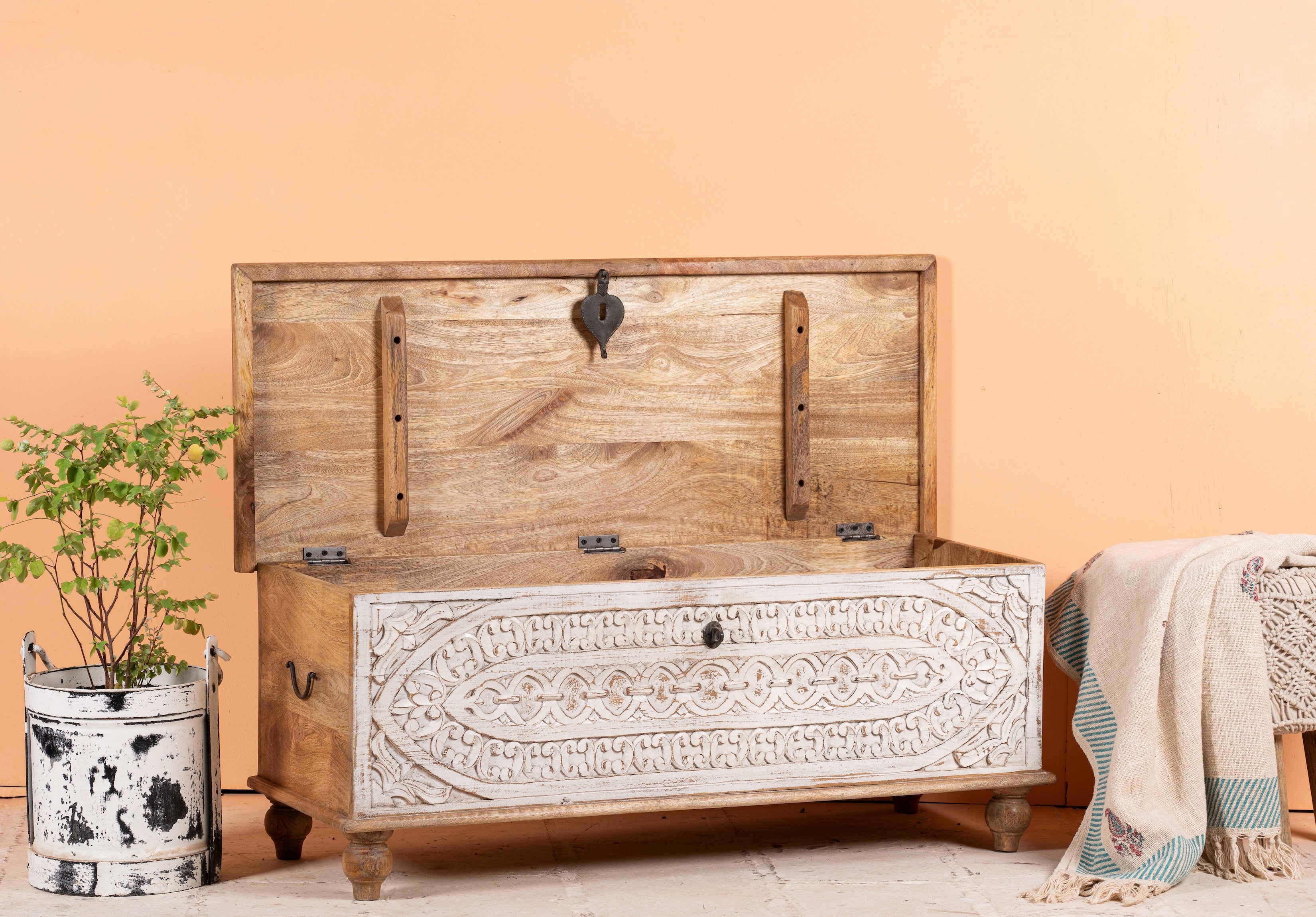 Image with open lid of a hand-carved mango wood vintage chest with whitewashed finish and iron fittings – elegant storage for bohemian or rustic interiors.