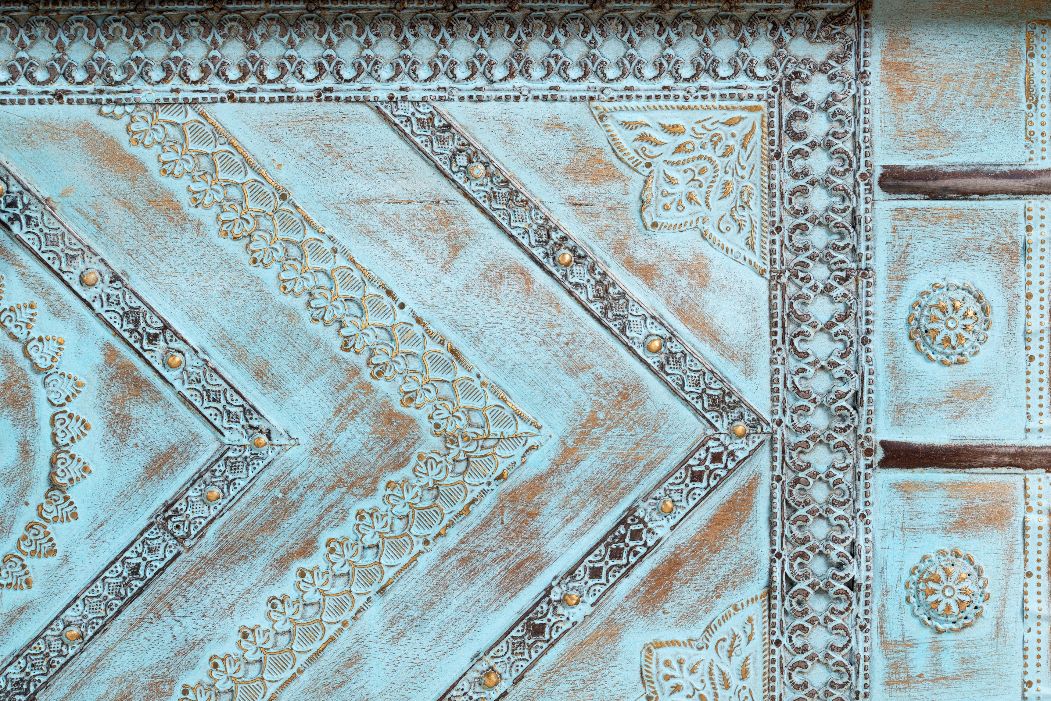 Close up image of a blue hand-carved mango wood chest with floral and geometric carvings – wood chest box perfect for boho style storage or decorative accent.